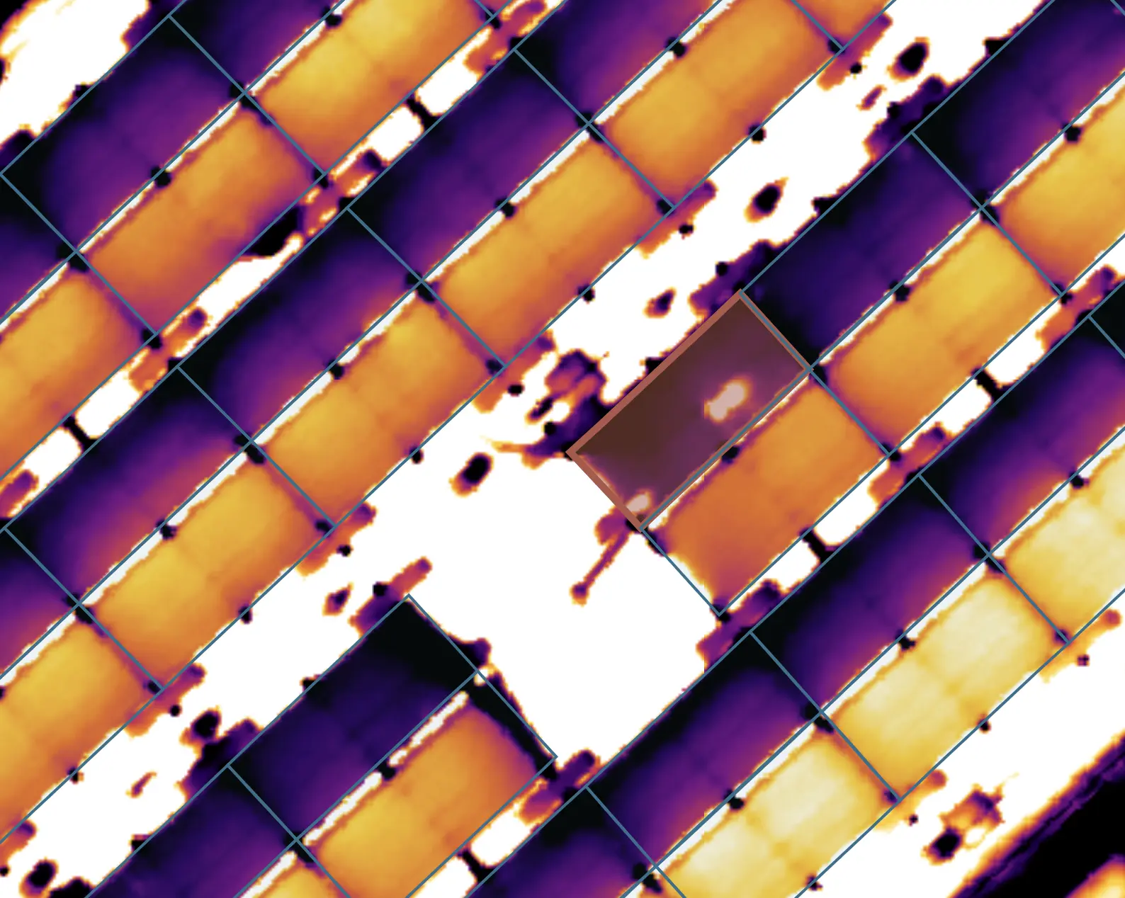 The same faulty solar panel highlighted around a cell-sized hotspot on the thermal map